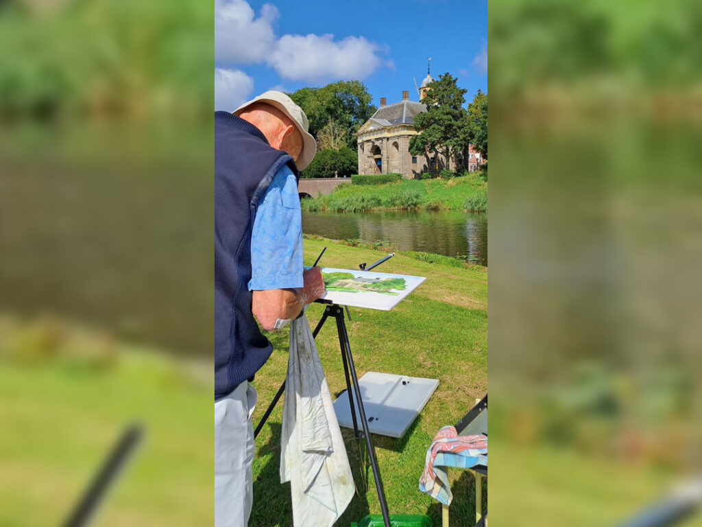 man schildert de koepoort in enkhuizen tijdens sow to grow evenement
